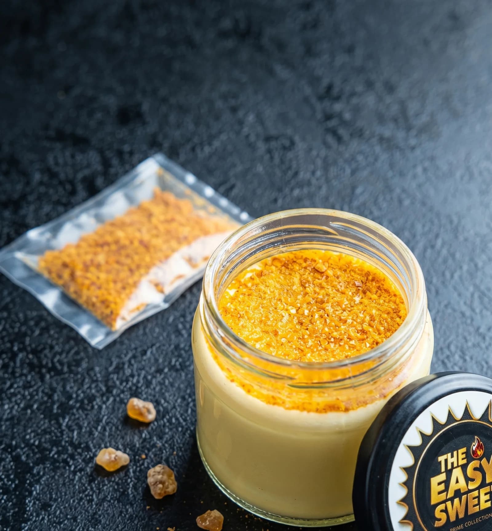 Crème brûlée in a glass jar with its sugar sachet